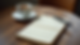 High angle view of a journal and pen beside a cup of tea on a cozy table
